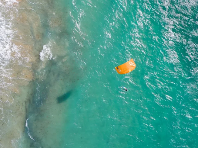 Aerial view of kitesurfing in turquoise water in Tarifa