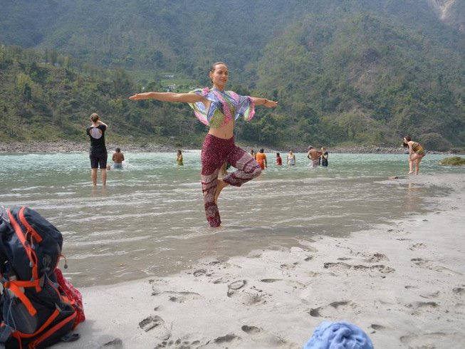 Woman doing Yoga on the beach in an enchanting spot for yoga retreats in India